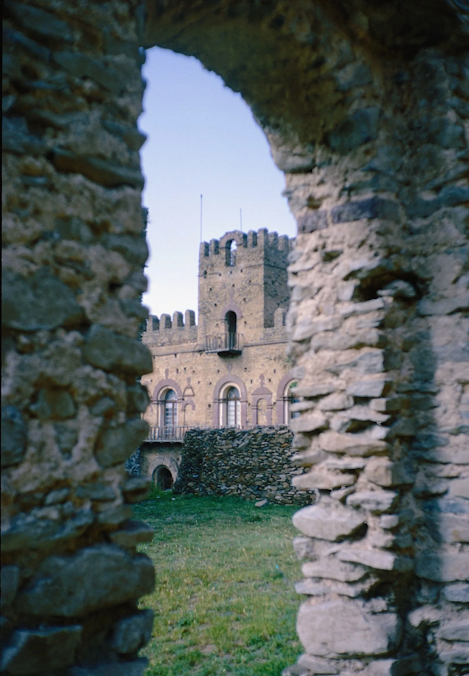A castle within Fasil Ghebbi in Gondar, seen through a stone arch