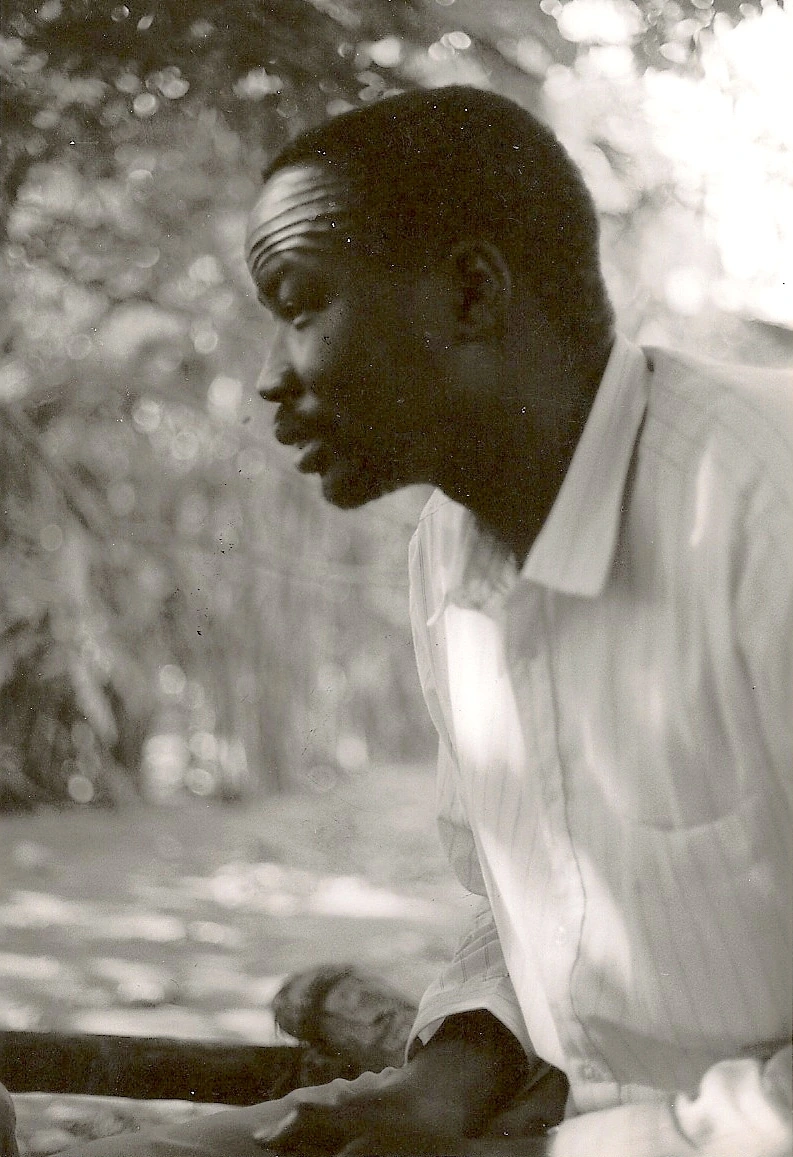 The Reverend James Duot Dol listens during a storytelling session in Gambela