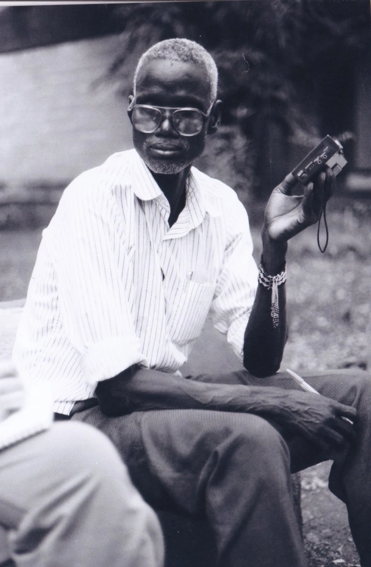 Ogota Agiw holds a portable cassette recorder during the Gambela story-collecting journeys