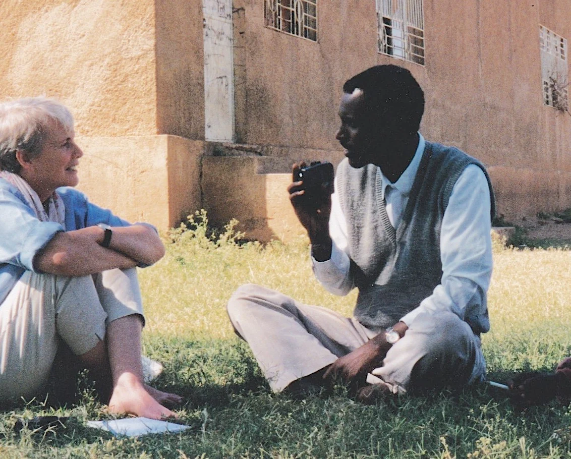 Elizabeth Laird listens as Moge Abdi Omer speaks into a portable cassette recorder